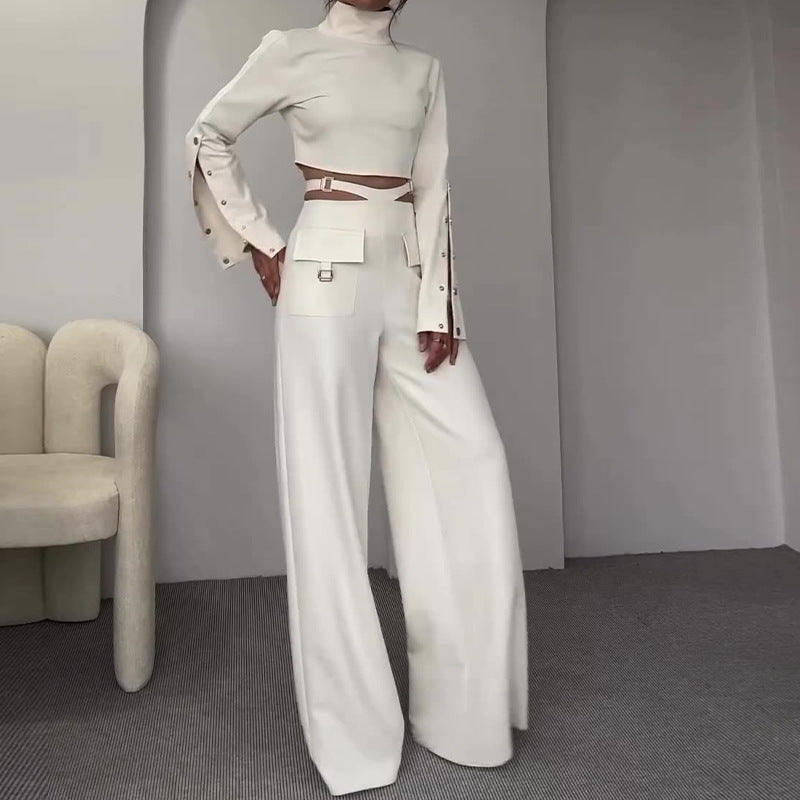 A loose-fitting KIKIMORA suit with wide legs and a high, midriff-baring collar.