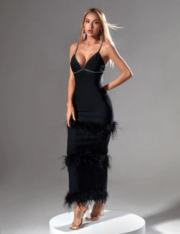 Slim evening dress with a neckline, a slit at the back and trim with rhinestones and ostrich feathers