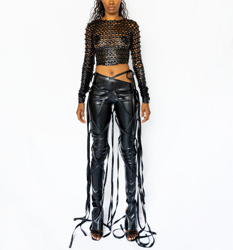 KIKIMORA Trousers with an oblique waist, made of faux leather.